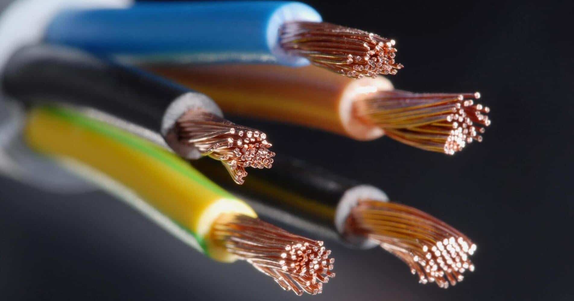 Close-up of exposed ends of colorful electrical wires, showcasing copper strands.